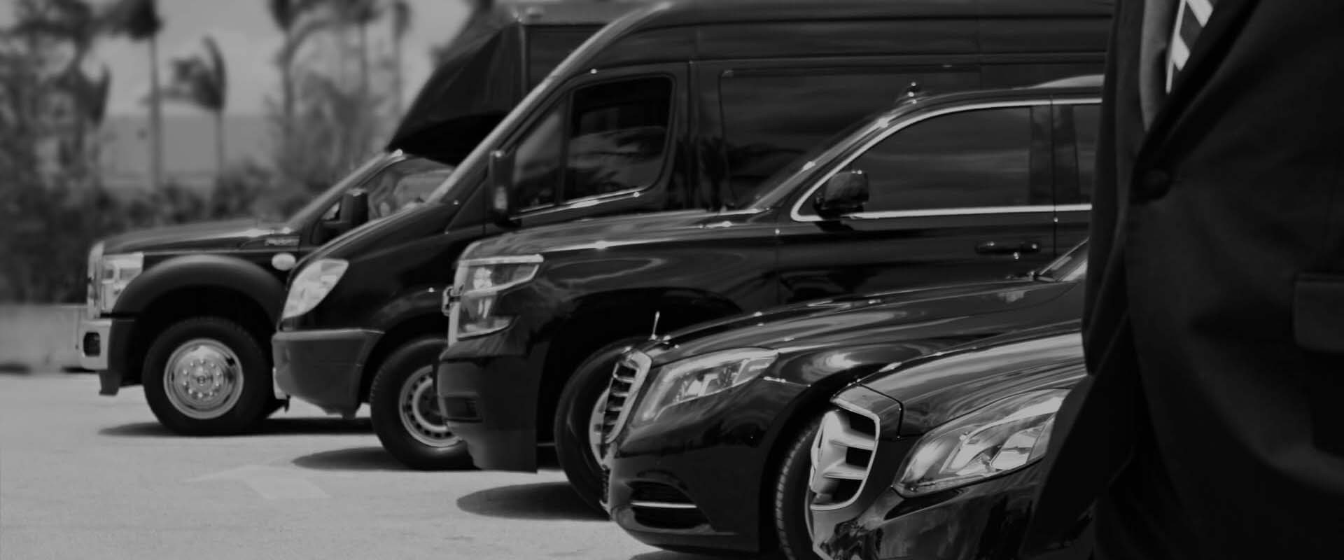 Professional Miami chauffeur opening luxury vehicle door for client
